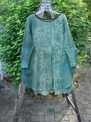 Barclay Thermal Contrast Revival Top Botanicals Green Storm OSFA, displayed on a clothes rack, showcases ribbed sleeves and neckline with a botanical theme, perfectly embodying BlueFishFinder's vintage creative style.