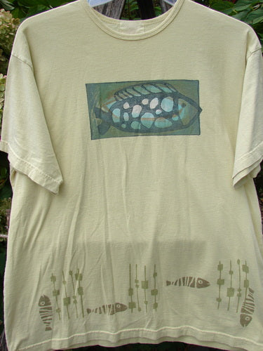1999 Short Sleeved Tee Single Fish Citron Size 1 features a stylized fish graphic on the chest and a pattern of fish silhouettes with plant-like stalks along the hem, showcasing Bluefishfinder.com's vintage creativity.