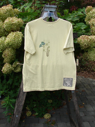 1999 Short Sleeved Tee Single Fish Citron Size 1 draped on a ladder, showcasing a fish motif and Blue Fish signature patch, embodying Bluefishfinder's vintage style and individuality-focused ethos.