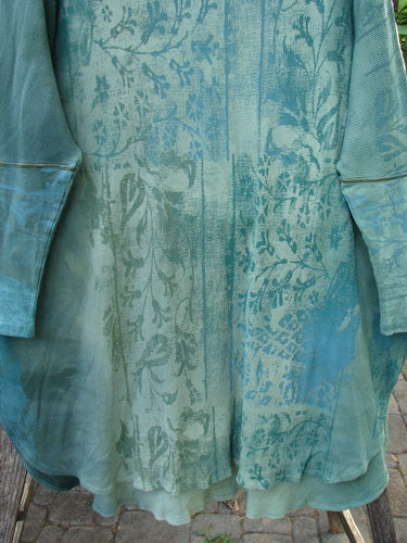 Close-up of the Barclay Thermal Contrast Revival Top Botanicals in Green Storm, showcasing ribbed sleeves, rounded neckline, and botanical pattern, highlighting Bluefishfinder.com's commitment to unique, vintage-inspired fashion.