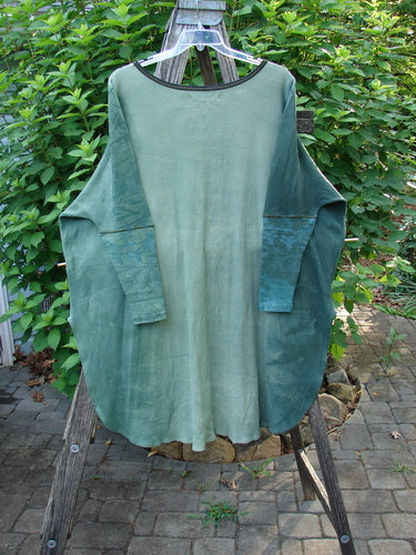 Barclay Thermal Contrast Revival Top Botanicals Green Storm OSFA displayed on a clear swinger, showcasing its ribbed sleeves, rounded neckline, and botanicals theme, representing Bluefishfinder.com's vintage-inspired, expressive style.