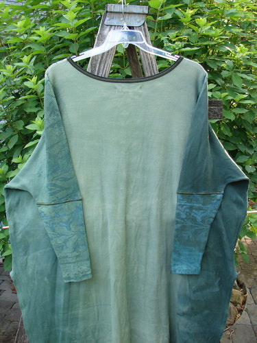 Barclay Thermal Contrast Revival Top Botanicals Green Storm OSFA displayed on a hanger, showcasing its ribbed sleeves, rounded neckline, and unique botanicals theme, highlighting its fall collection design.