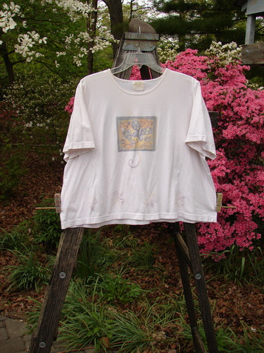 1999 Light Weight Short Sleeved Crop Tee Butterfly Orchid Size 2 displayed on a swing, showcasing its unique butterfly-themed design and vintage Blue Fish patch.