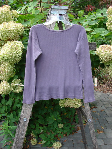 1998 Pointelle Long Sleeved Under Top Unpainted Modena Size 1 draped on a weathered wooden ladder, showcasing its soft rib knit pattern, rolled neckline, and cozy, slightly longer sleeves.
