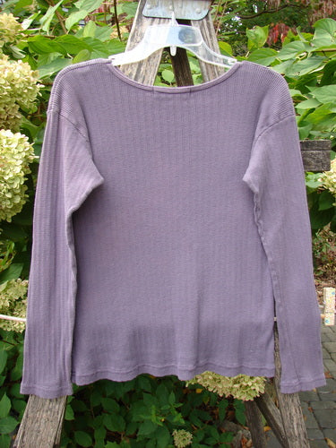 1998 Pointelle Long Sleeved Under Top Unpainted Modena Size 1 displayed on a clear hanger against a rustic ladder, highlighting its ribbed knit texture, cozy rolled neckline, and unique pointelle pattern, ideal for layering.