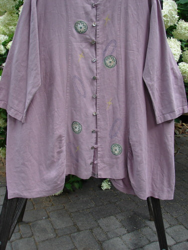 1999 Parlor Jacket with circle floral design, size 2. Linen fabric, V-neckline, gathered front and back, side pockets, painted tab, sectional panels, widening shape, varying hemline.
