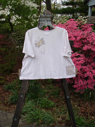 1999 Light Weight Short Sleeved Crop Tee Butterfly Orchid Size 2 displayed on a wooden stand, showcasing the butterfly design and unique A-line flair.