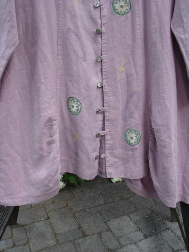 1999 Parlor Jacket with circle florals in heliotrope, size 2. Close-up of a purple shirt with abalone buttons, V neckline, gathered front and back, side pockets, and painted tab.