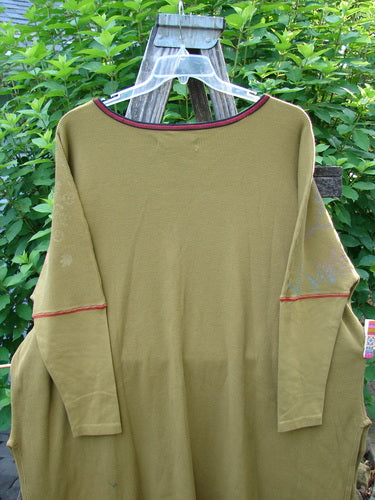Barclay Thermal Contrast Revival Top Botanicals Yellow Olive OSFA displayed on a swinger, showcasing ribbed sleeves, a rounded neckline, and botanical theme paint, emphasizing creative freedom in fashion.