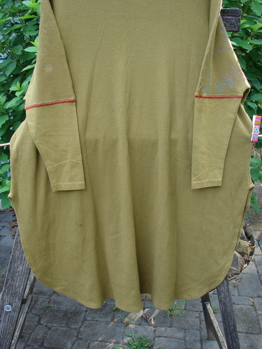 Barclay Thermal Contrast Revival Top in Yellow Olive features ribbed sleeves and neckline with a botanical theme, ideal for expressing creativity and individuality. Perfect condition, showcased on a stone walkway.