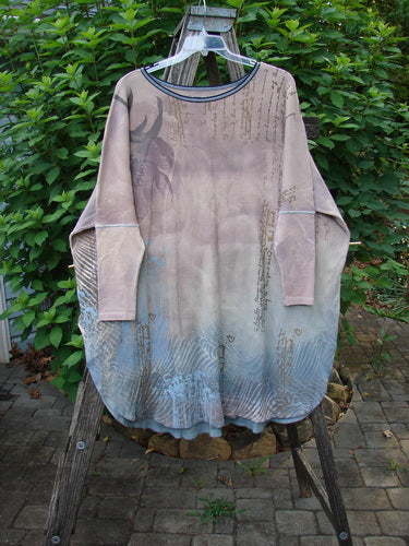 Barclay Thermal Contrast Revival Top Script Pastels OSFA displayed on a wooden pole, showcasing its distinctive ribbed sleeves, rounded neckline, and A-line shape, epitomizing Bluefishfinder.com's creative vintage fashion ethos.