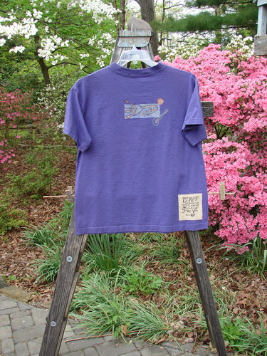 Vintage 1996 Short Sleeved Tee Drum Niagara Size 0 on wooden easel. Features include ribbed neckline, drop shoulders, boxy shape, and drum theme. From Bluefishfinder.com, offering unique vintage Blue Fish Clothing.