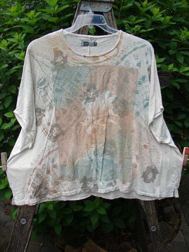 Barclay Cotton Slub Cricket Cap Sleeve Tee Stone Blossom Creme OSFA displayed on a hanger, highlighting its seamless shoulder sleeve, slight hip flare, and unique stone blossom pattern design.