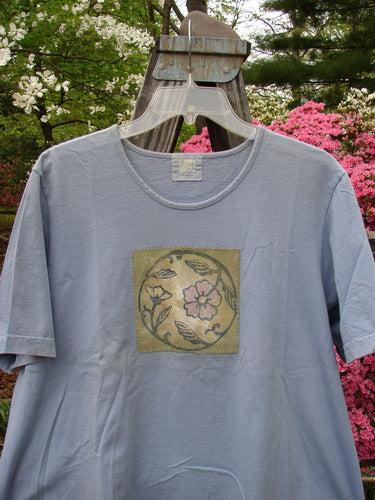 1999 Patched Short Sleeved Crop Tee Floral Medallion Bluestone Size 1 displayed on a hanger, highlighting its rolled neckline and signature Blue Fish patch.