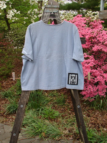 1999 Patched Short Sleeved Crop Tee Floral Medallion Bluestone Size 1 on a clothes rack, showcasing its feminine rolled neckline and signature Blue Fish patch.