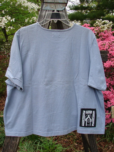 1999 Patched Short Sleeved Crop Tee Floral Medallion Bluestone Size 1 on a clothes rack, showcasing a classic floral medallion patch and a feminine rolled neckline in perfect condition.