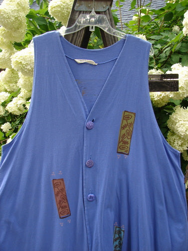 1997 Simple Vest Flower Sprig Skylark Size 2: A blue vest with buttons featuring a sweet flower sprig theme patch on the lower back. Deep side pockets and oversized knotted textured buttons. Made from organic cotton.