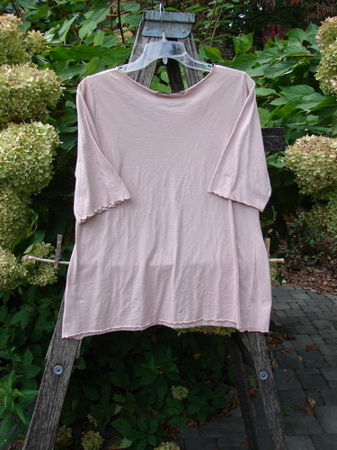 Barclay Batiste Curl Edge Layer Top Unpainted Blush Size 1, displayed on a hanger, highlights a curly neckline and hem against a wooden ladder backdrop, embodying BlueFishFinder's vintage, expressive style.