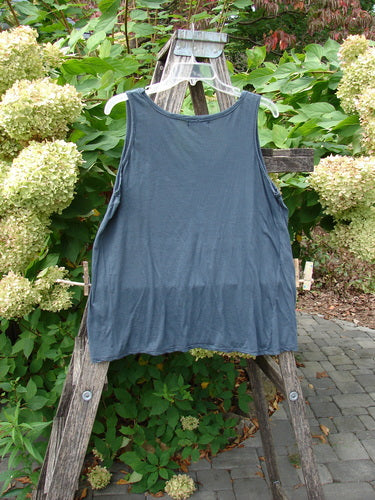 Barclay Batiste Decora Tiny Tank Unpainted Navy Size 2 draped on a white hanger over a wooden ladder, showcasing its sleeveless design and slight A-line shape with a front vertical neckline tie.