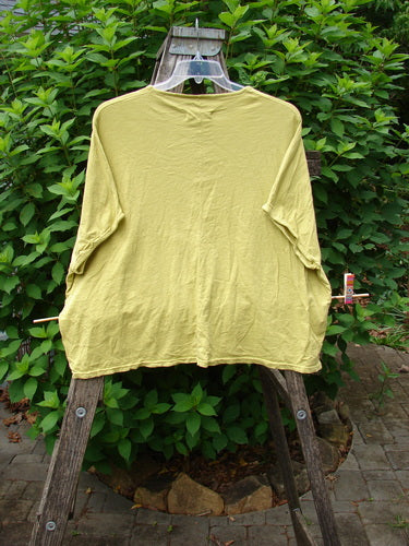 Barclay Cotton Slub Cricket Cap Sleeve Tee Home Citron OSFA displayed on a wooden rack, showcasing its cool cap sleeves and seamless shoulder design, reflecting Bluefishfinder.com's unique vintage style.
