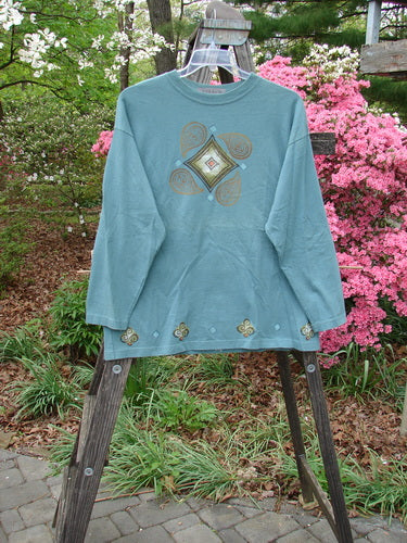 Vintage 1997 Long Sleeved Tee in Cypress, Size 1, showcasing a diamond theme paint design. Made from organic cotton, featuring a wider ribbed neckline and cozy longer sleeves. From BlueFishFinder's collection of unique vintage Blue Fish Clothing.