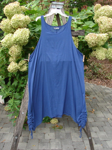 Barclay Batiste Side Gather Back Draw Shift Dress Unpainted Royal Blue Size 2 displayed on a wooden stand. Features sleeveless design, scoop neckline, and adjustable side gathers for a ruched hem effect.