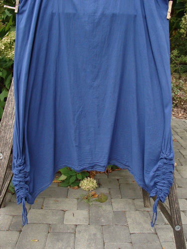 Barclay Batiste Side Gather Back Draw Shift Dress Unpainted Royal Blue Size 2, hanging on a drying rack, showcasing its seamless design, adjustable side gathers, and rounded neckline.
