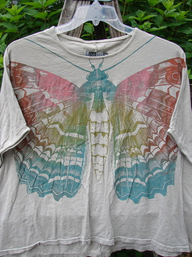 Barclay Cotton Slub Cricket Cap Sleeve Tee Butterfly Flax OSFA features a butterfly garden design, seamless cap sleeves, and a boxy shape, embodying Bluefishfinder.com's vintage, expressive fashion ethos.