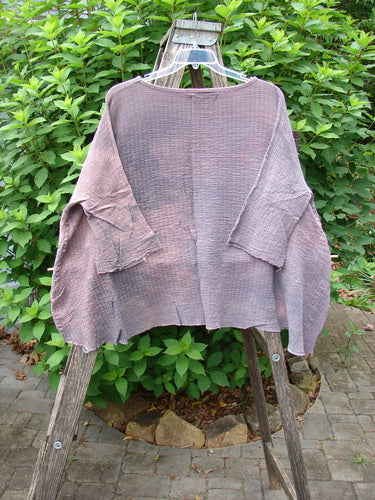 Barclay NWT Crinkle Gauze Top in Mottled Smokey Rose Quartz displayed on a stand, showcasing its high-low hemline and three-quarter dolman sleeves, emphasizing the top's airy crinkle cotton texture.