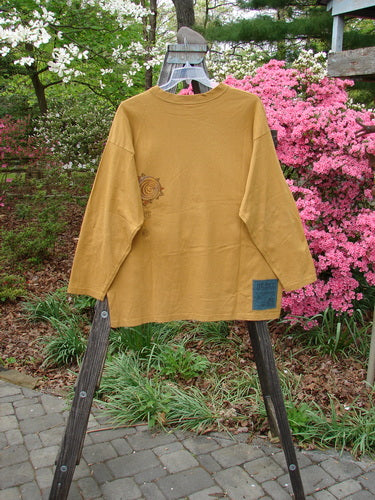 Vintage 1996 Long Sleeved Tee with Falling Heart design in Old Gold, Size 2. Features a ribbed neckline, Blue Fish patch, and organic cotton fabric. From BlueFishFinder's Holiday Collection, embodying creative freedom and individuality.