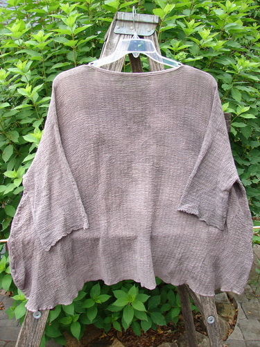 Barclay Crinkle Gauze Top Mottled Steaming Latte OSFA displayed on a hanger, showcasing its wide, boxy design with a high-low hemline and three-quarter dolman sleeves, embodying Bluefishfinder.com's vintage, creative expression.