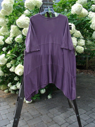Barclay Gather Front Pocket Dress in Dusty Plum, Size 2. A lovely dress with a dip side varying hemline, sweet front vertical gather, and A-line shape. Features two exterior front drop pockets. Unpainted.