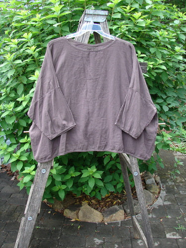 Barclay Twill Atmosphere Overlayer Boxy Top Unpainted Stick OSFA on a wooden rack, showcasing its featherweight cotton twill texture, flowy boxy shape, and three-quarter-length dolman sleeves.