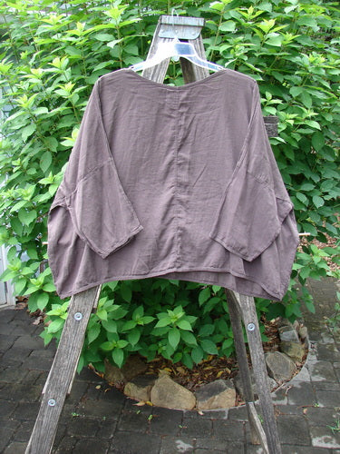 Barclay Twill Atmosphere Overlayer Boxy Top Unpainted Stick OSFA displayed on a wooden ladder with its boxy, flowy shape and three-quarter-length dolman sleeves, highlighting its lightweight, textured cotton twill fabric.