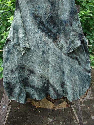 Barclay Crinkle Gauze Ana Tunic Dress Unpainted Mottled Forest OSFA on a clothes rack, showcasing its wide three-quarter sleeves, seamless shoulder, and varying hemline, embodying Bluefishfinder.com's vintage, creative style.