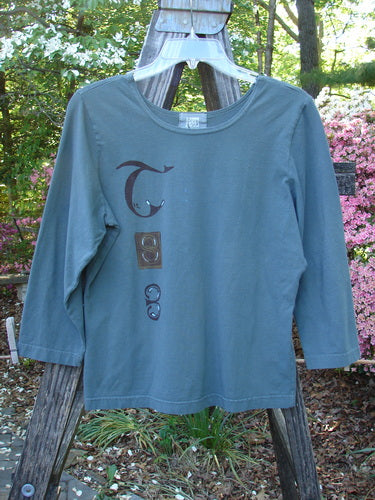 Vintage 2000 Cotton Lycra Three Quarter Sleeve Layering Top with Celtic Park design on a hanger. From BlueFishFinder, offering unique Vintage Blue Fish Clothing by Jennifer Barclay. Size 0.