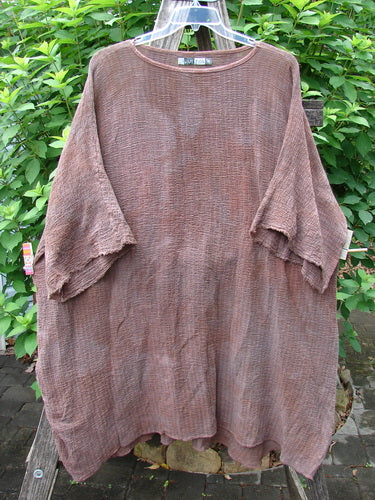 Barclay Crinkle Gauze Ana Tunic Dress Unpainted Mottled Copper OSFA displayed on a clothes rack, showcasing its slightly shallow rounded neckline, wide three-quarter sleeves, and varying hemline.