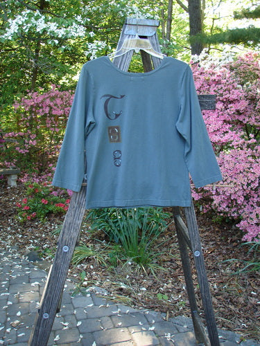 Vintage 2000 Cotton Lycra Three Quarter Sleeve Layering Top with Celtic Park design on wooden stand. From BlueFishFinder, offering unique vintage Blue Fish Clothing by Jennifer Barclay since 1986.