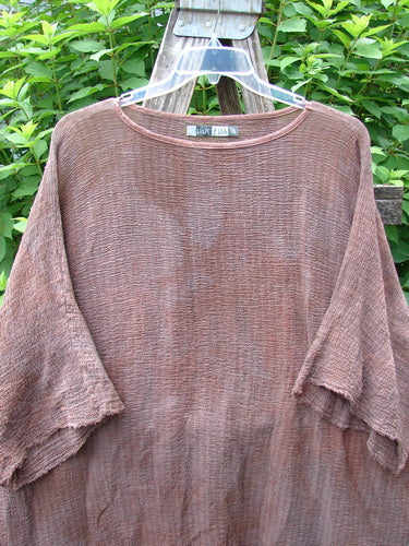 Barclay Crinkle Gauze Ana Tunic Dress in Mottled Copper features wide three-quarter sleeves, a shallow neckline, and varying hemline, displayed outdoors on a wooden surface, reflecting Bluefishfinder.com's vintage aesthetic.