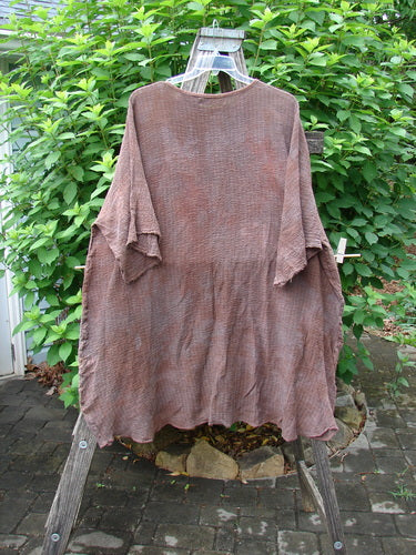 Barclay Crinkle Gauze Ana Tunic Dress Unpainted Mottled Copper OSFA displayed on a clothes rack, showcasing its flowing, lightweight cotton gauze fabric, wide sleeves, and seamless shoulder design.