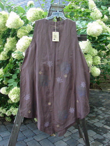 1998 NWT Hemp Silk Sanjo Vest, Boxwood, Size 2: A brown dress on a wooden stand, with a long brown vest and a screw on a wood post.