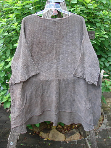 The Barclay NWT Crinkle Gauze Ana Tunic Dress in Mottled Latte features a slightly shallow rounded neckline, wide three-quarter sleeves with frays, and a varying hemline, showcasing its generous, lightweight design.