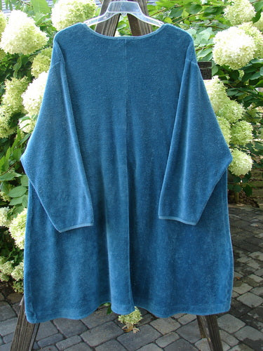 Barclay Chenille Rippie Tie Front Robe Jacket Unpainted Teal Size 2 displayed on a swing, showcasing its double drop front pockets, A-line shape, and smooth vertical cotton paneling.