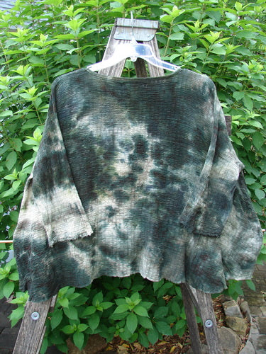 Barclay Crinkle Gauze Crop Top Mottled Forest Black Sky OSFA displayed on a wooden rack, showcasing its high-low hemline, dolman sleeves, and square boxy cut, reflecting Bluefishfinder.com's vintage aesthetic.