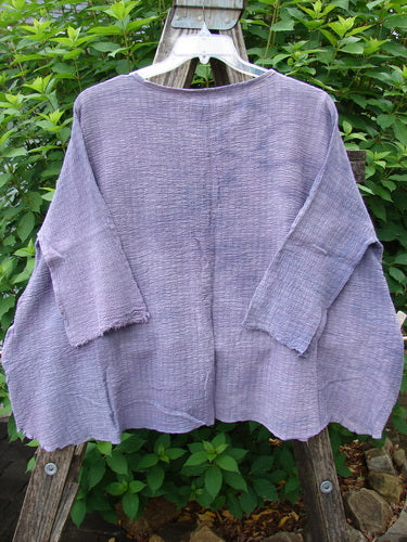 Barclay NWT Crinkle Gauze Crop Top Mottled Smokey Lilac OSFA displayed on a hanger, showcasing its three-quarter dolman sleeves, high-low hemline, and rolled neckline in a lightweight crinkle cotton gauze fabric.