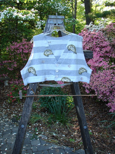 1996 Bumblebee Vest Ladybug Gray Flight Stripe Size 2 displayed on a wooden easel, featuring feathered stripes, whimsical ladybug, two white buttons, and a boxy, cropped shape with deep arm openings.