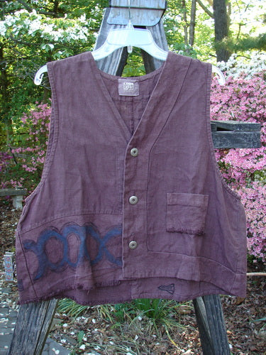 2000 Poet's Vest Celtic Loam Size 1 displayed on a swing, featuring offset front pocket, double-paneled hemline, metal buttons, feathered accents, and unique front seams.