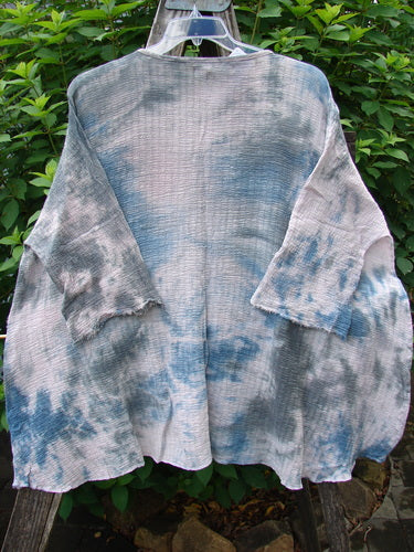 Barclay NWT Crinkle Gauze Top in Mottled Pink Gray Celestial OSFA, featuring a high-low hemline, three-quarter dolman sleeves, and a rolled neckline, displayed on a clothes rack.