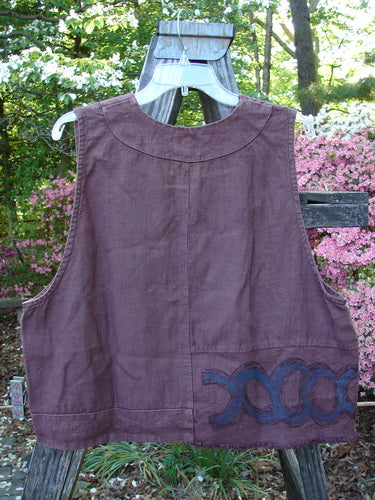 2000 Poet's Vest Celtic Loam Size 1 displayed on a hanger, featuring metal buttons, offset feather edge pocket, unusual front seams, and feathered accents, highlighting the vintage charm of Bluefishfinder.com.