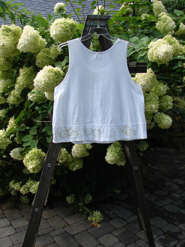 2000 PMU Patched Sun Tank Quiet Vine Cloud White Size 1 displayed outdoors, showcasing its swingy A-line cropped shape, scooped neckline, and tiny button pocket, embodying Blue Fish's playful vintage style.
